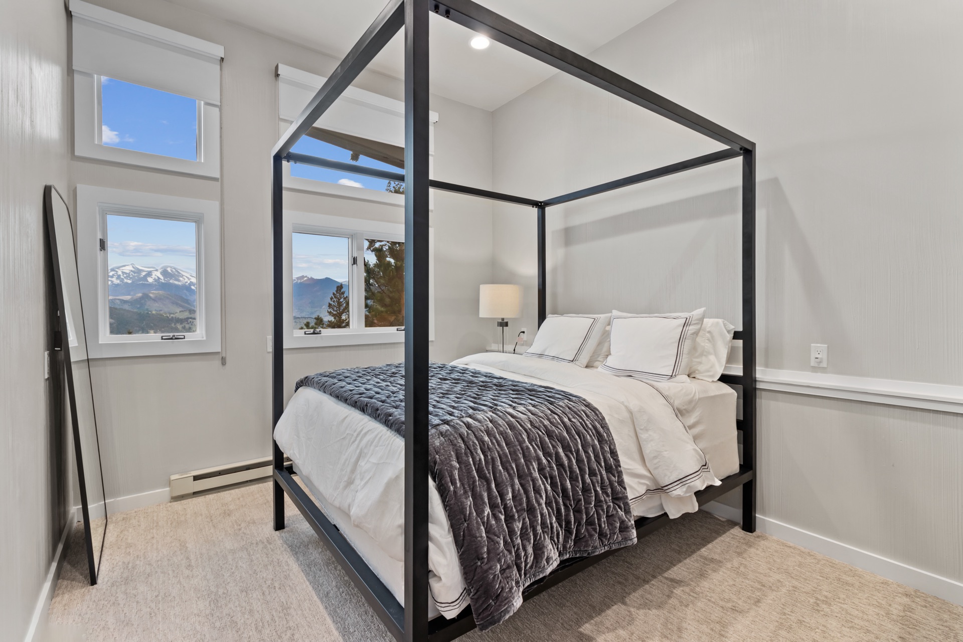 Main floor bedroom with queen bed and gray velvet bedding