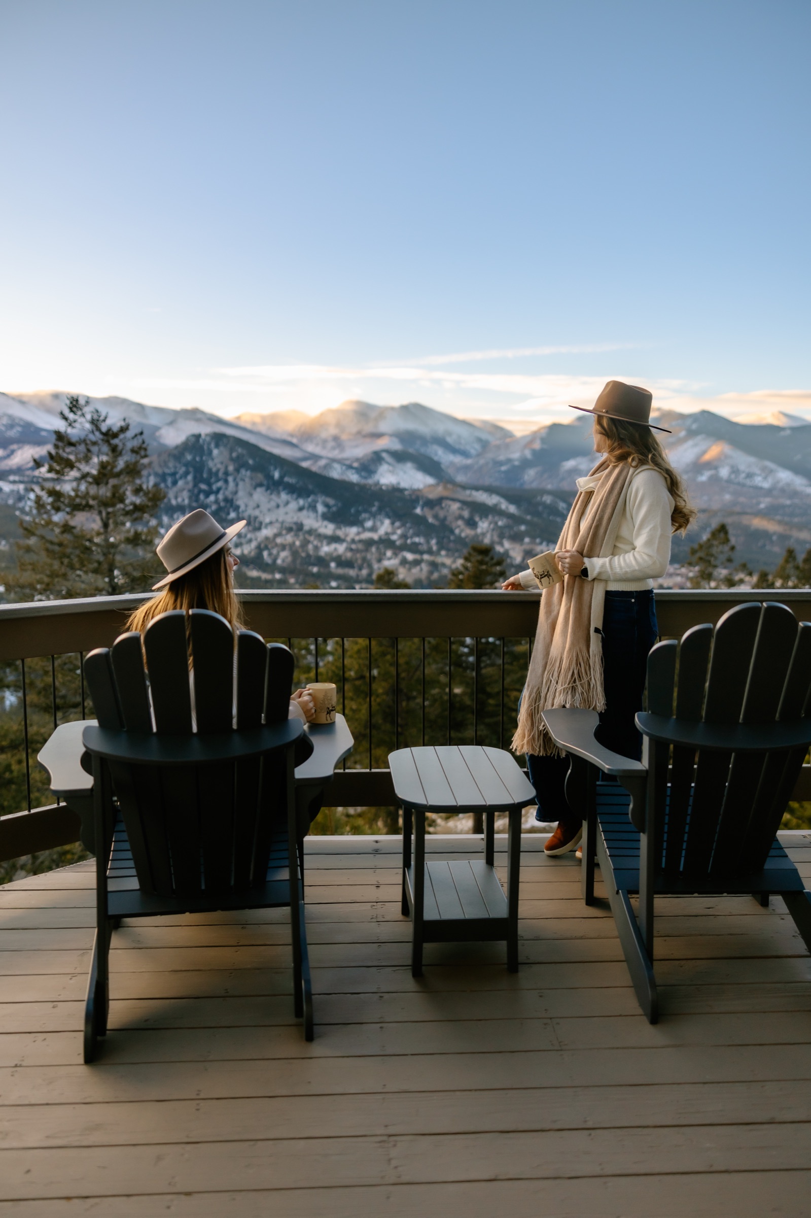 Guests on the Casa de Cristal deck at golden hour, mountains in the distance