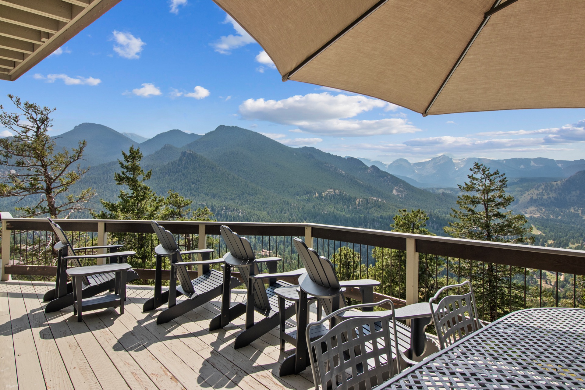 Outdoor deck with Adirondack chairs and mountain panorama