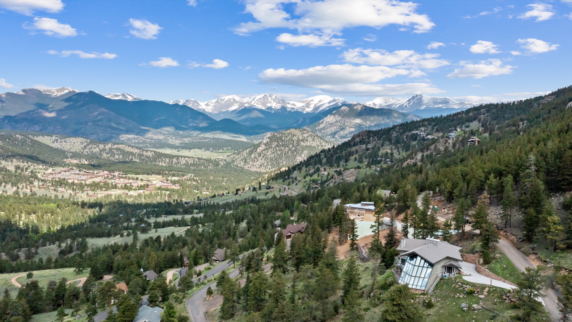Drone shot of Casa de Cristal roof and mountain views