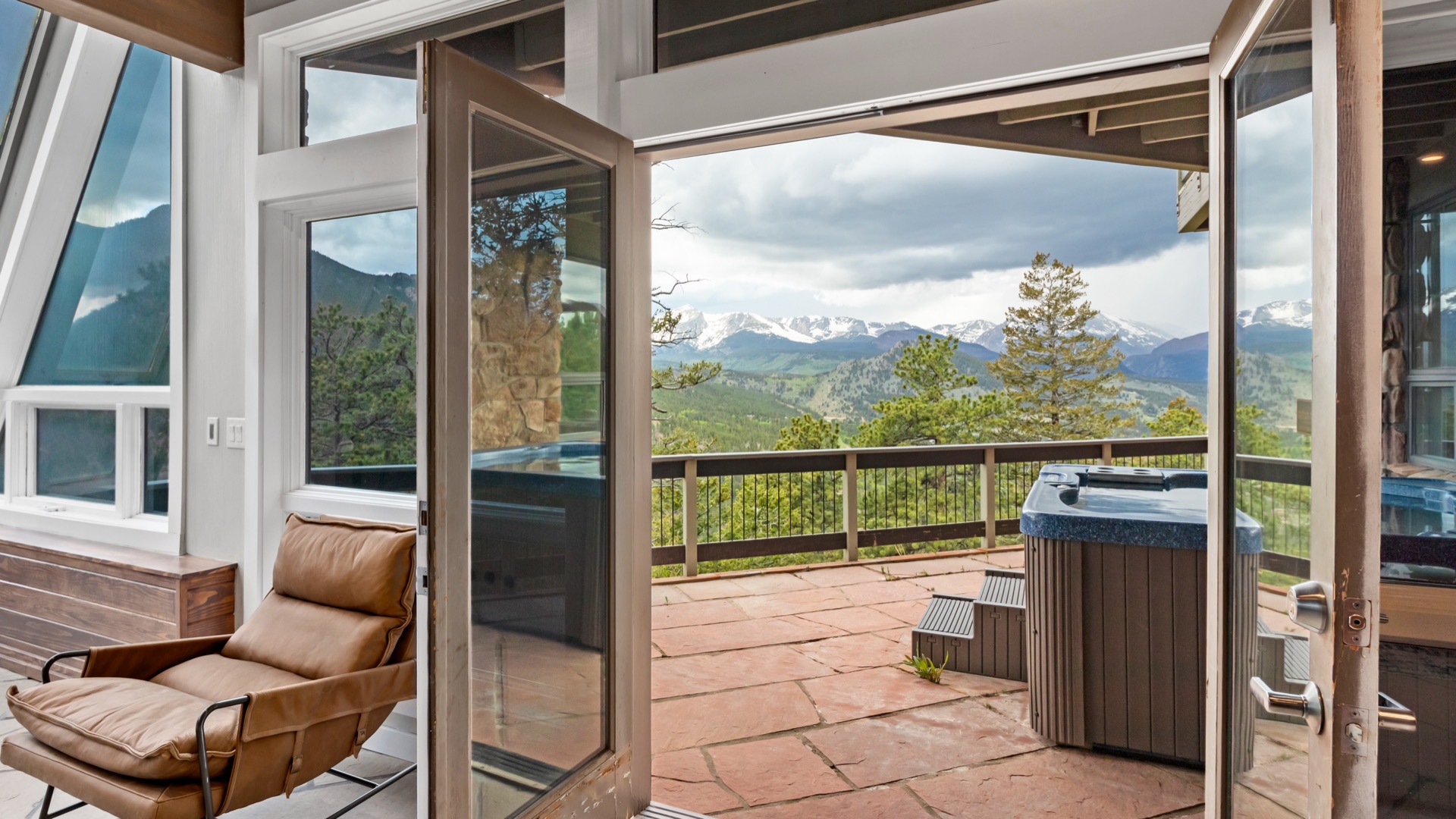 View through doors toward hot tub and mountains
