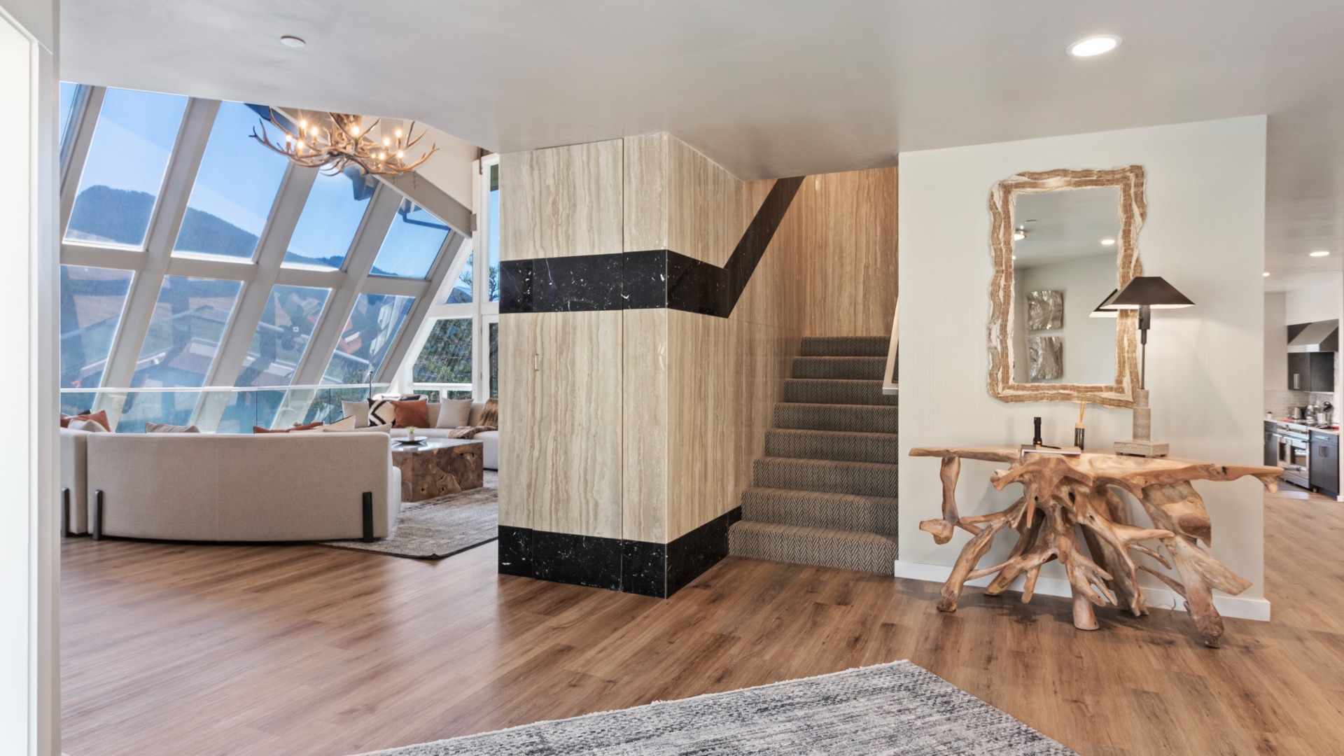Living room from alternate angle showing glass walls and modern furnishings