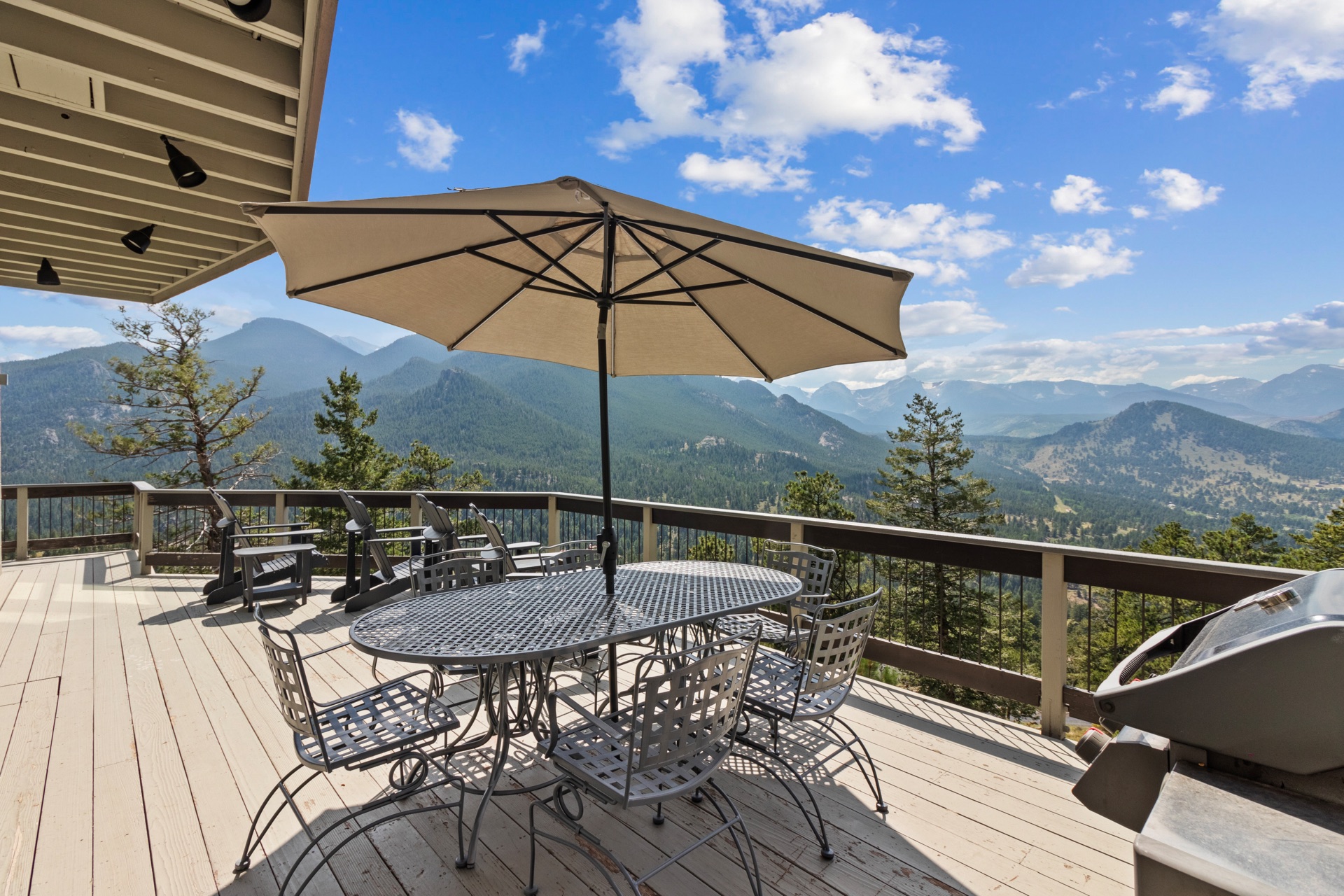 The patio features a dining table and an LP grill