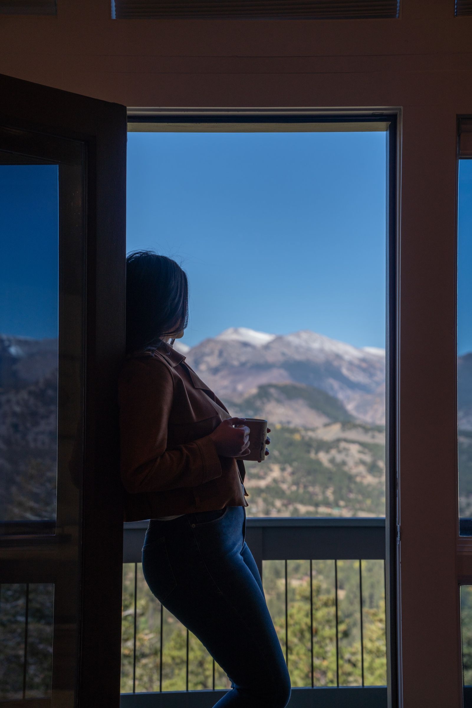 Morning coffee at an open door at Casa de Cristal, the Mummy Range beyond
