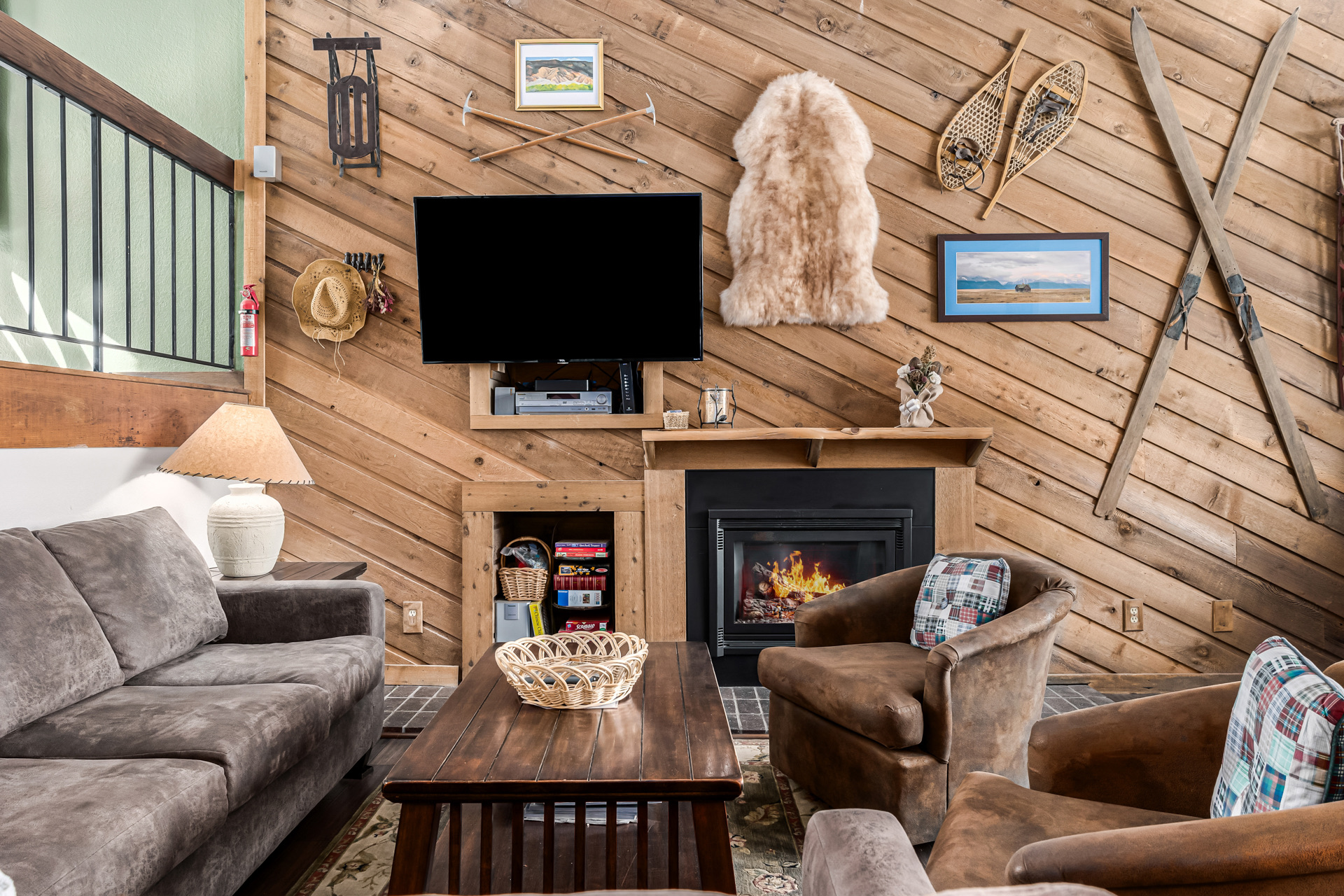 Living room with vintage ski decor and fireplace