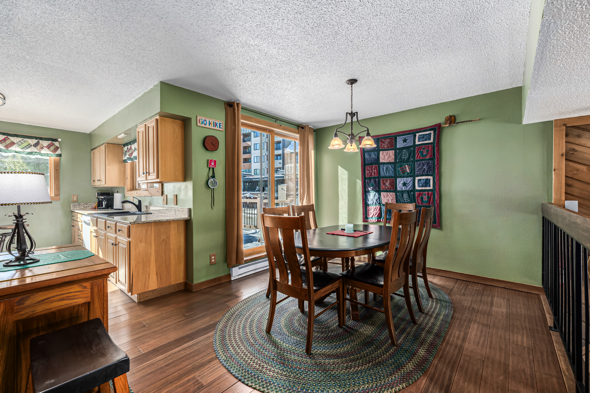 Kitchen and dining area with round table and pendant light