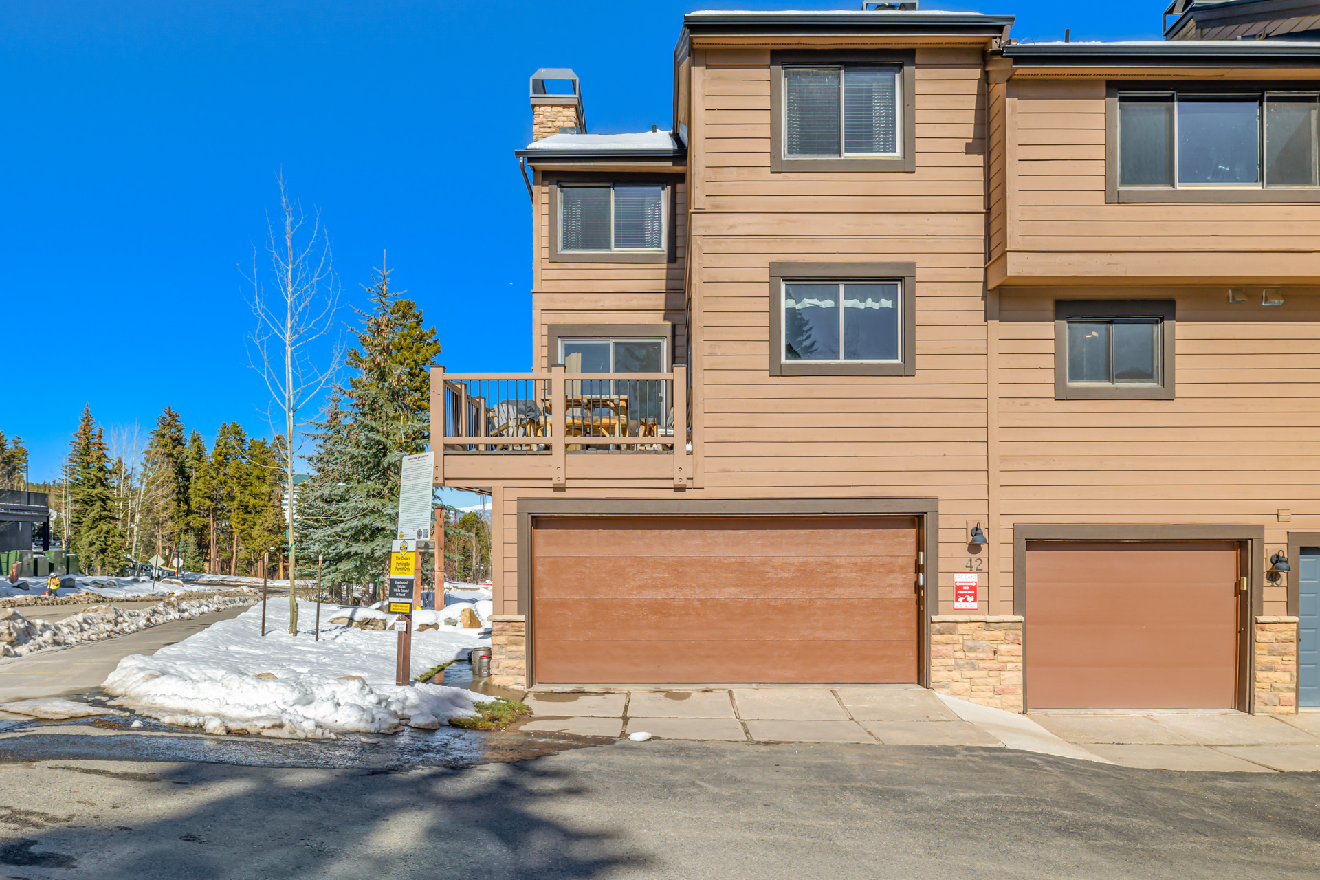 Cedars townhome exterior with garage and parking area