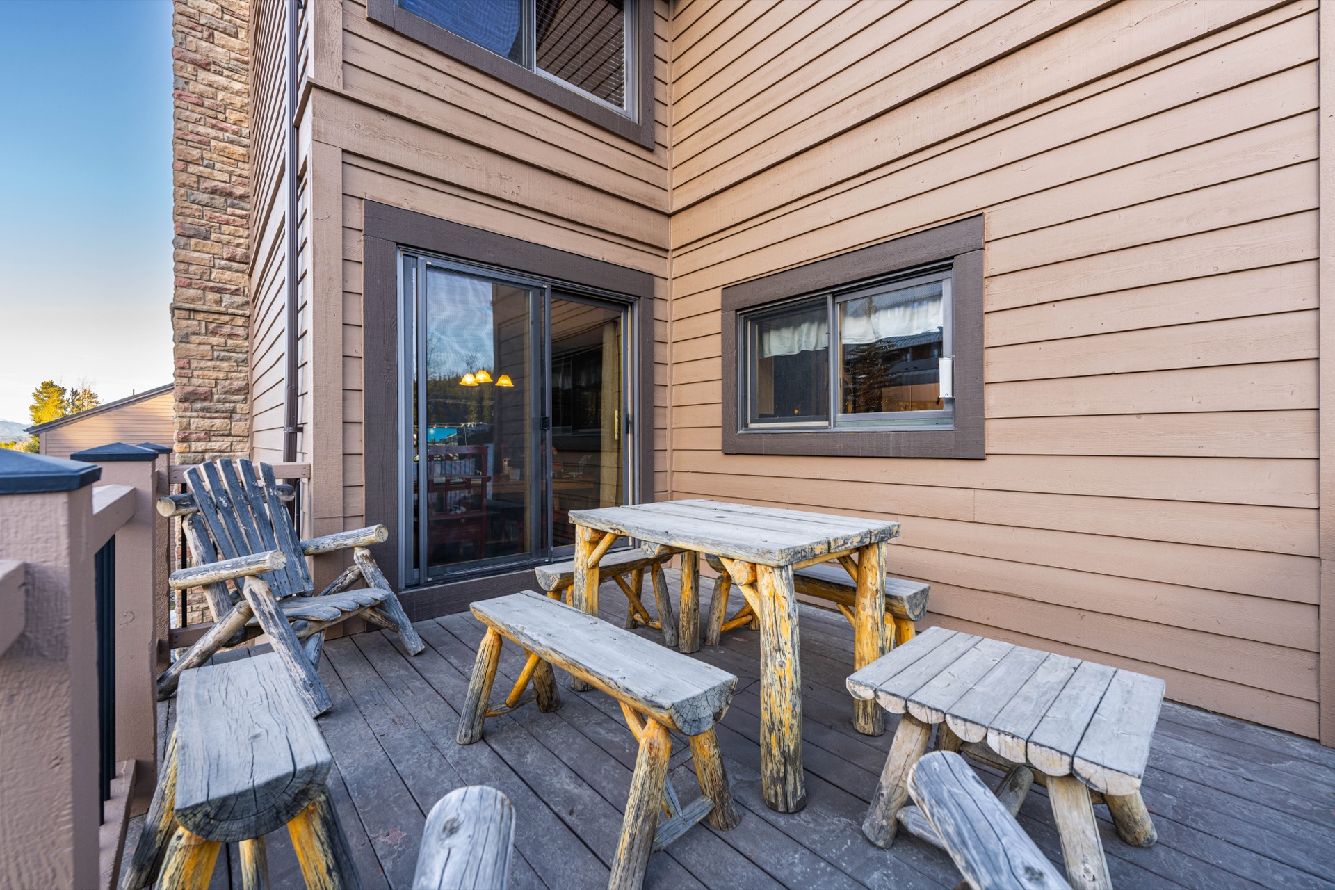 Deck with outdoor dining furniture and mountain backdrop