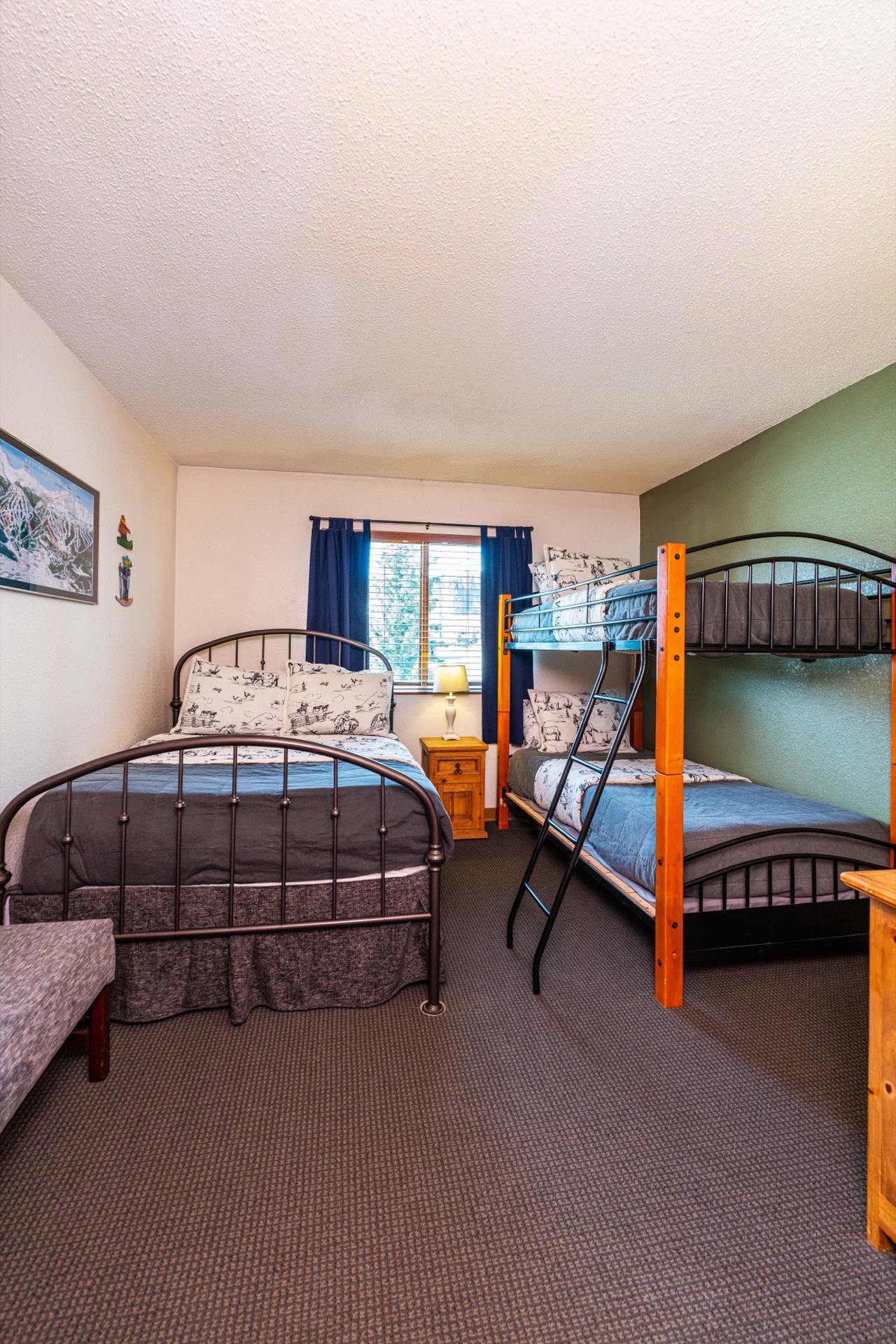 Bunk room with green accent wall and ski art