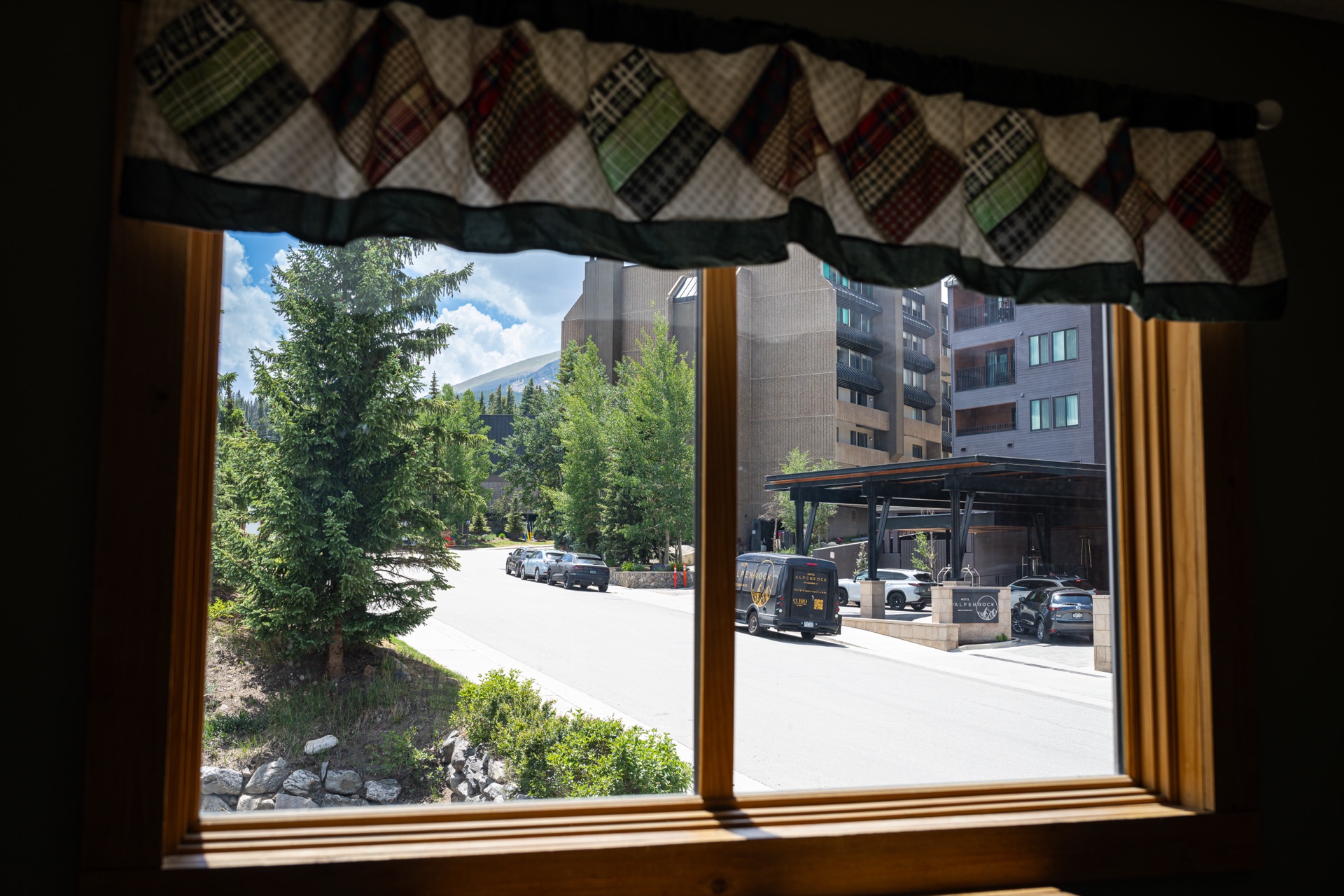 View through window to village and mountains