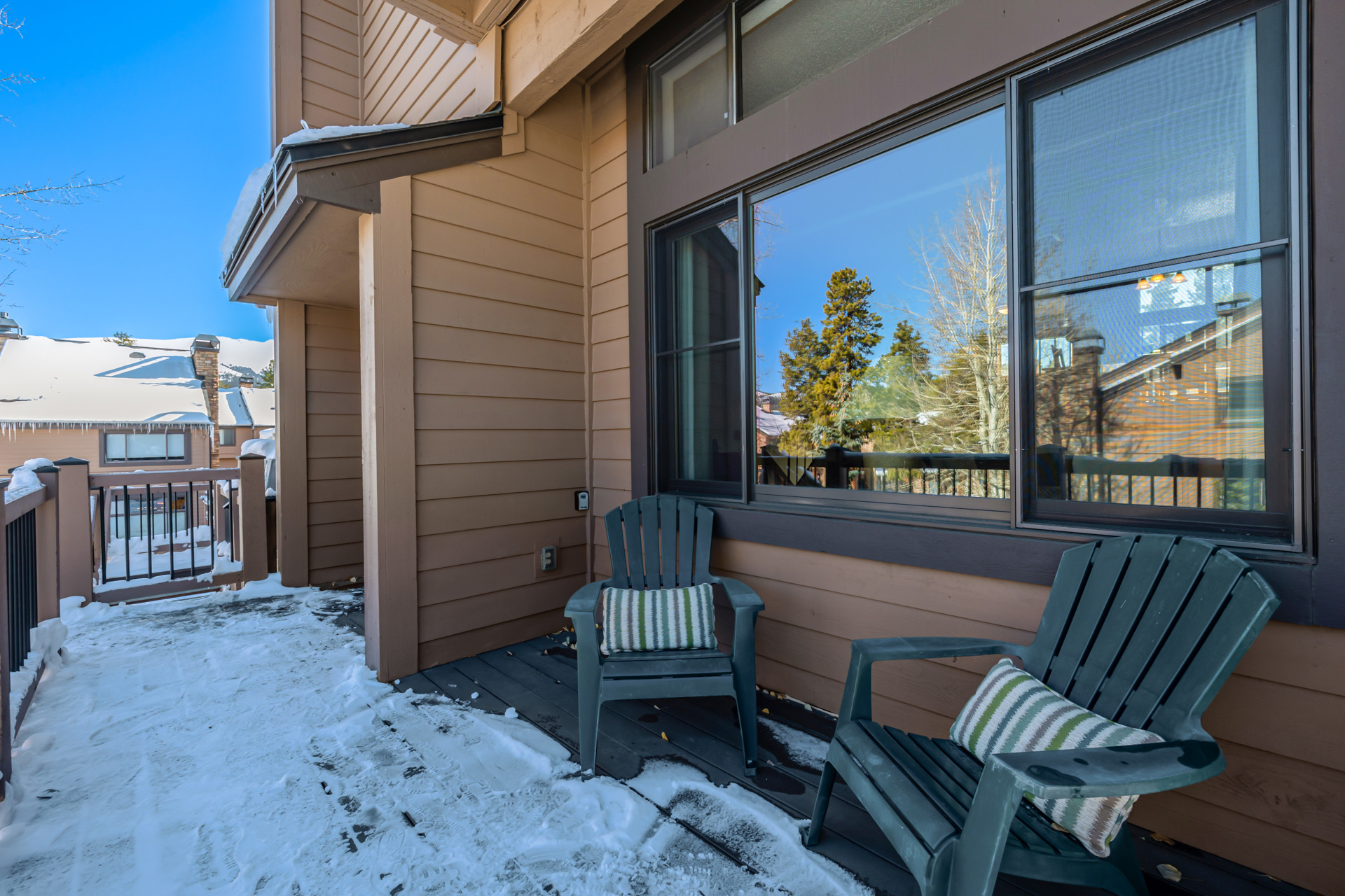 Winter deck with chairs and snowy views