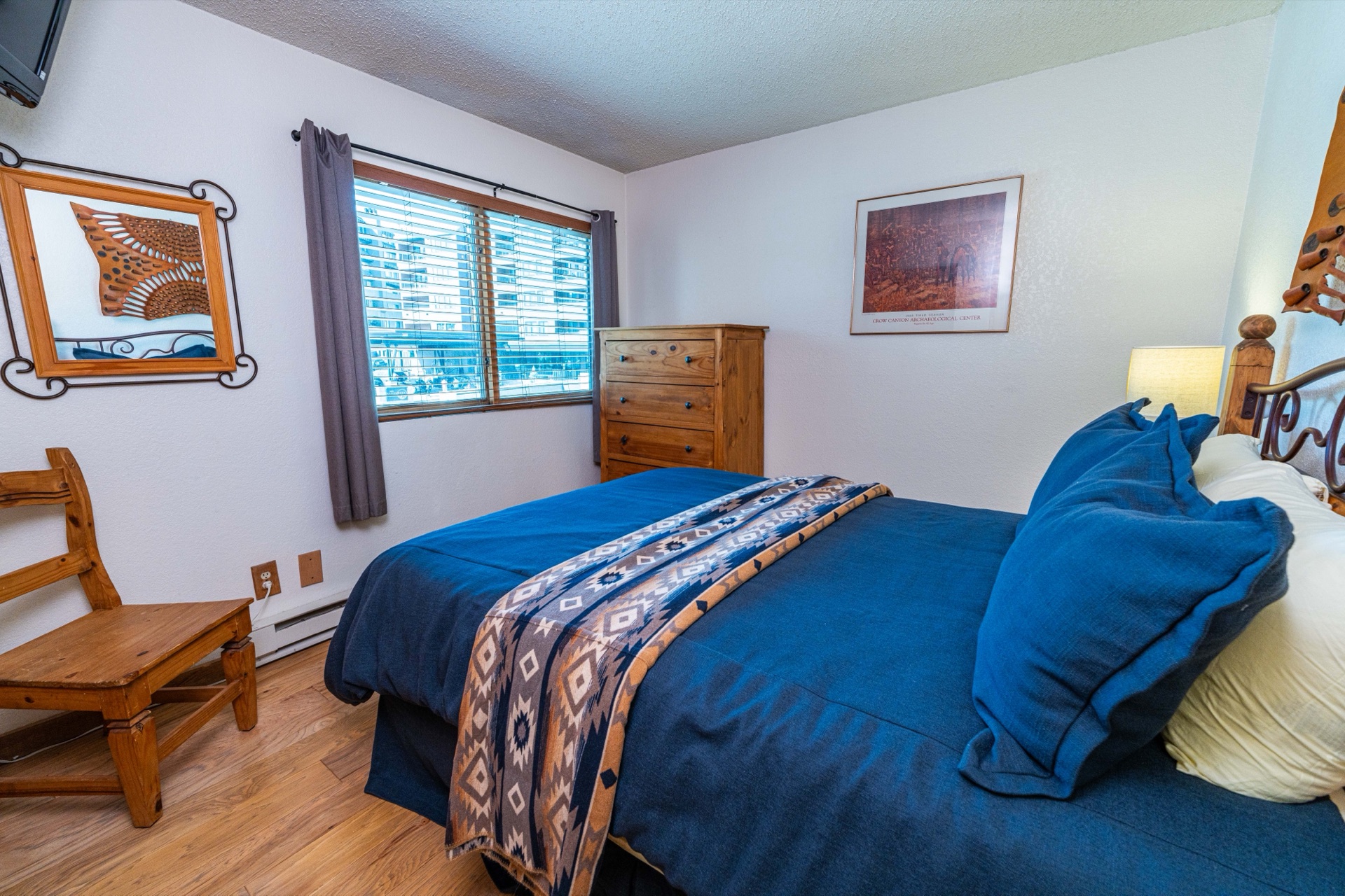 Second bedroom with queen bed and blue bedding