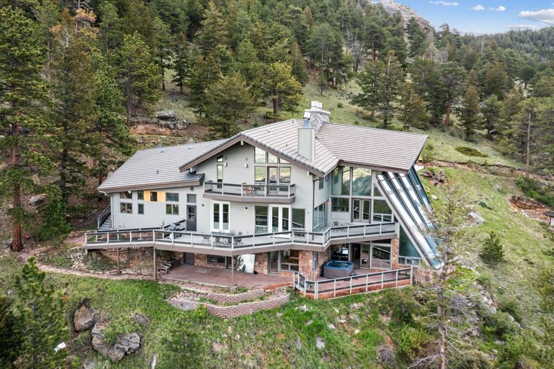 Wide aerial view of Casa de Cristal surrounded by pine forests