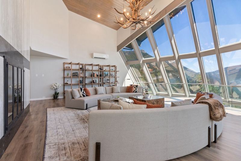 Seating area with mountain panorama through windows